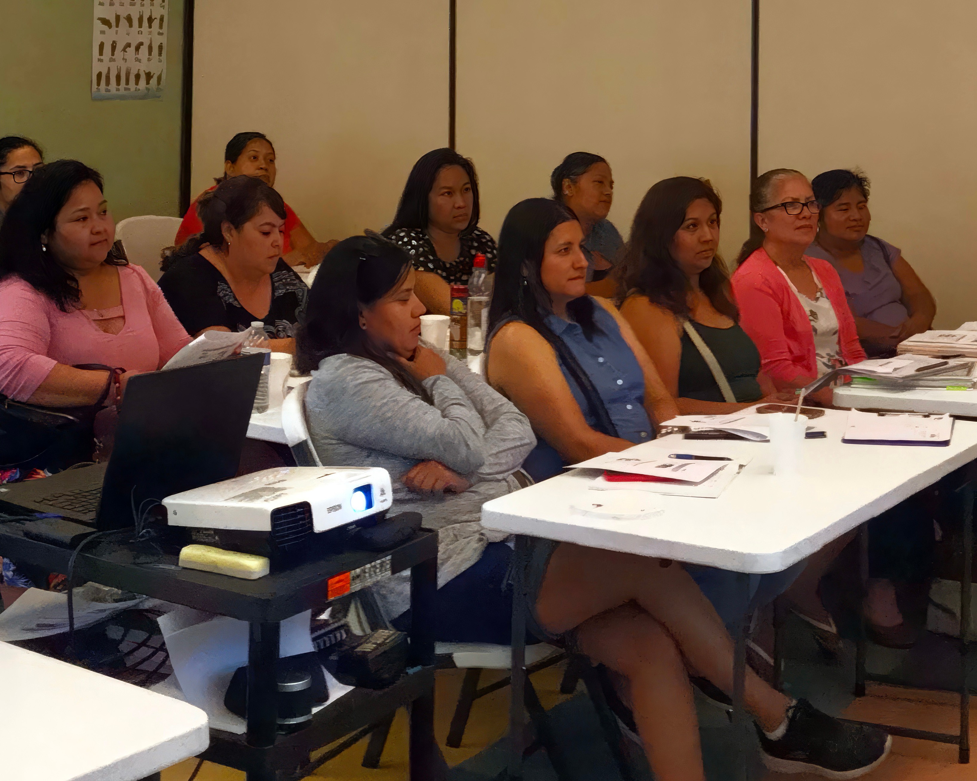 Portrait of a man with brown hair and glasses on a flat gray background.